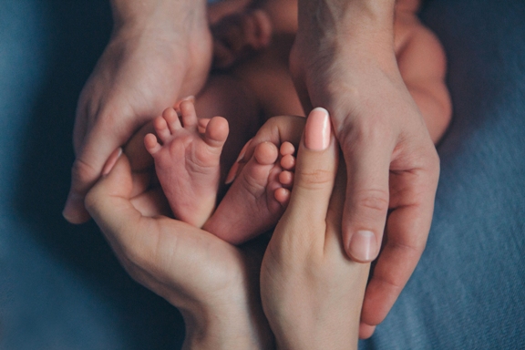 Newborn Baby's feet.Mother holding newborn baby legs,legs massage Newborn Baby's feet.Mother holding newborn baby legs,legs massage